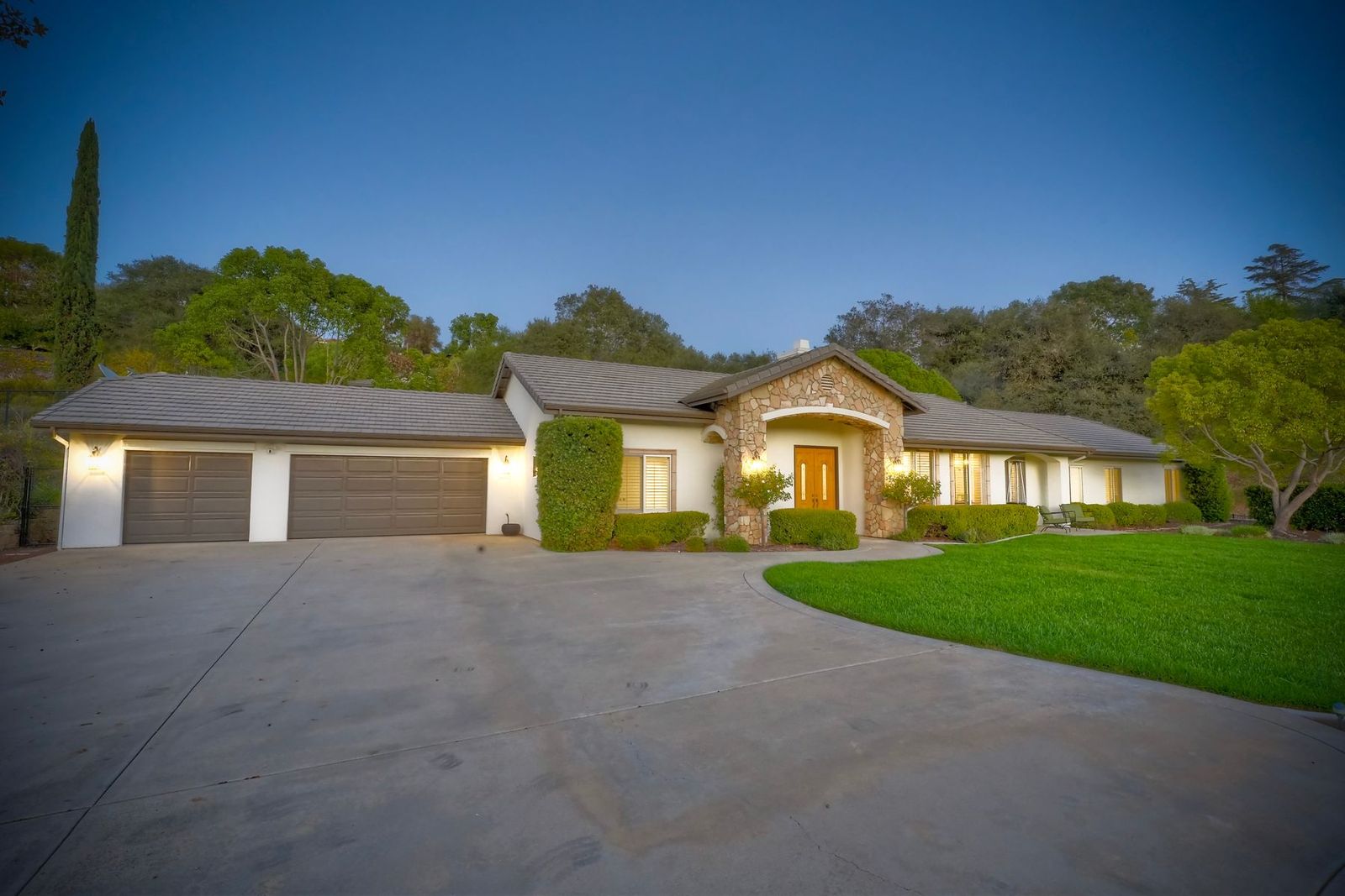 The home at dusk with lights on